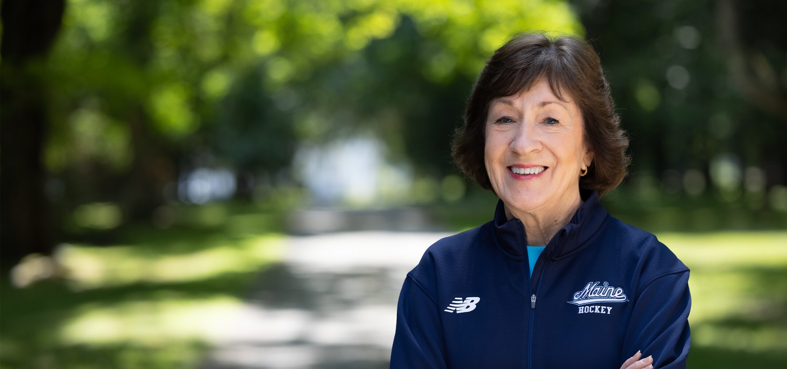 Senator Susan Collins on a tree-lined path in Maine